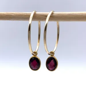 Gemstone earrings with garnet (dark red) oval crystal drops on gold large hoops