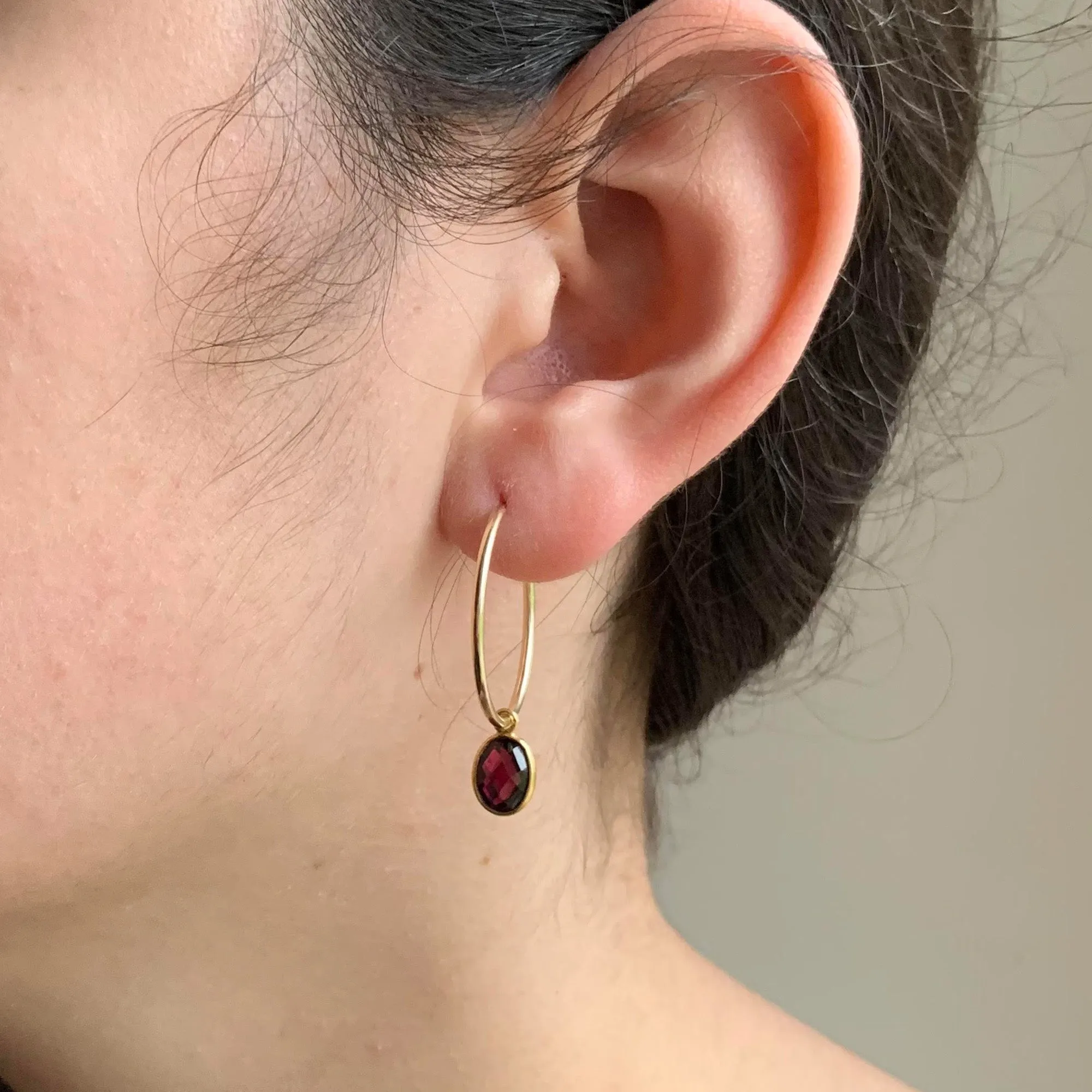 Gemstone earrings with garnet (dark red) oval crystal drops on gold large hoops